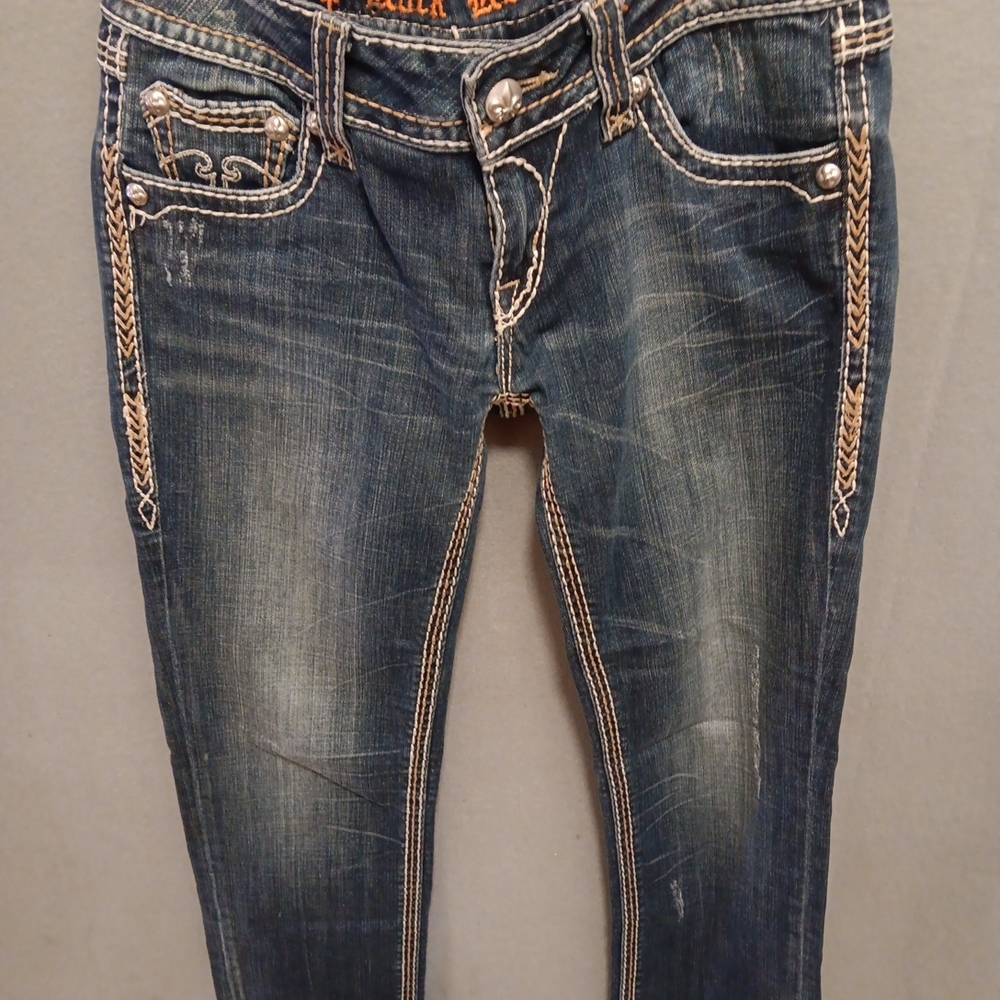 Rock Revival Blue Skinny Jeans with Natural Fading and Distressed Details.  A153